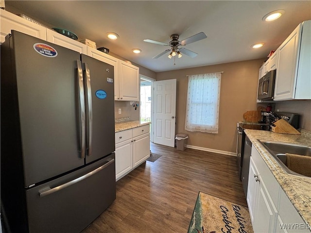 797 Van Rensselaer Ave, Niagara Falls, NY 14305 - kitchen with white cabinets, baseboards, a ceiling fan, and appliances with stainless steel finishes