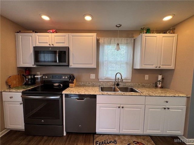 797 Van Rensselaer Ave, Niagara Falls, NY 14305 - kitchen with pendant lighting, dark wood-style flooring, a sink, white cabinetry, and stainless steel appliances