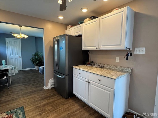 797 Van Rensselaer Ave, Niagara Falls, NY 14305 - kitchen featuring an inviting chandelier, freestanding refrigerator, white cabinets, dark wood-style flooring, and baseboards