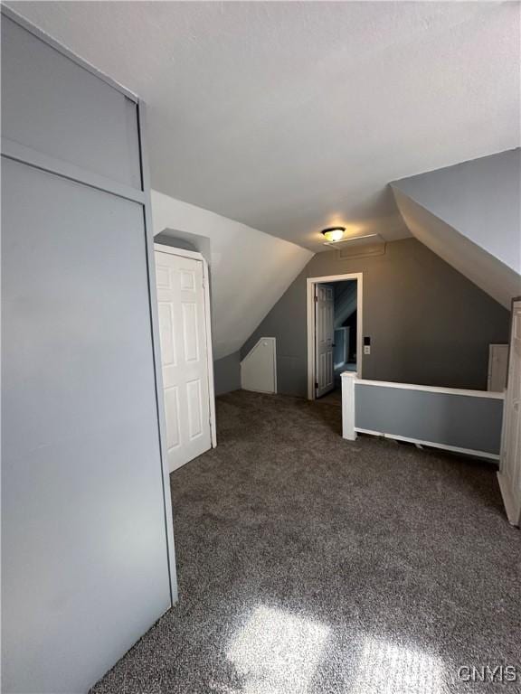 bonus room featuring carpet flooring and vaulted ceiling