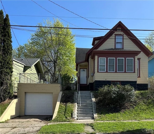 view of front of home with stairway, roof with shingles, a garage, and driveway