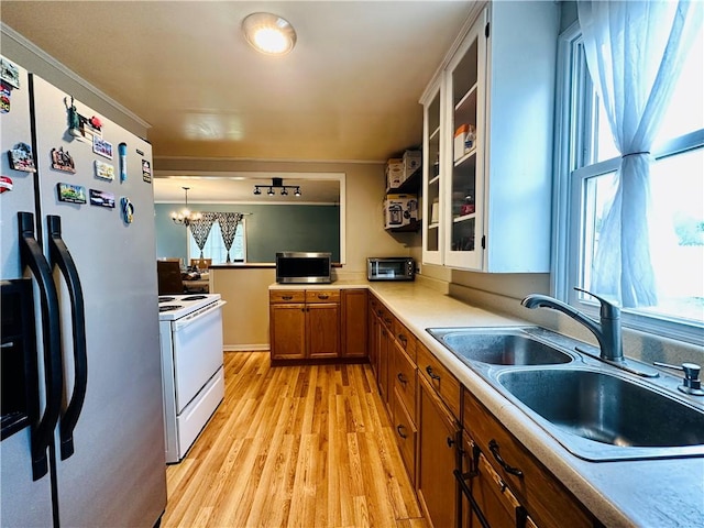 616 Hart St, Elmira-City, NY 14901 - kitchen with light wood-style flooring, a sink, stainless steel fridge with ice dispenser, electric stove, and brown cabinets
