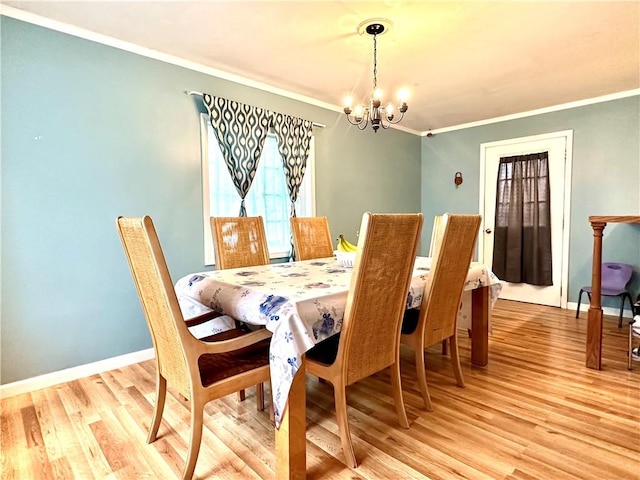 616 Hart St, Elmira-City, NY 14901 - dining space with a chandelier, crown molding, baseboards, and light wood-type flooring