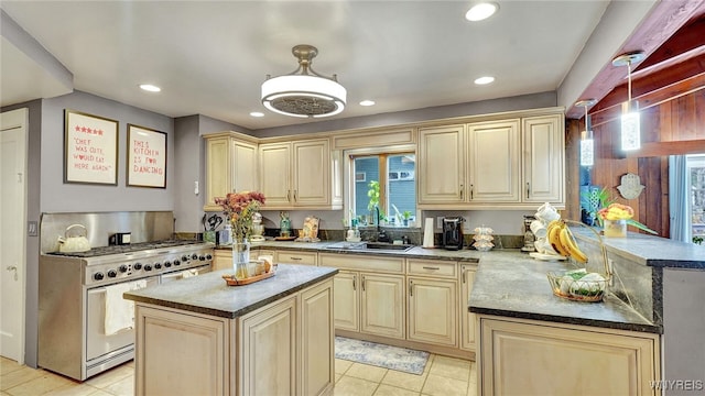 kitchen featuring recessed lighting, double oven range, light tile patterned flooring, a sink, and a peninsula