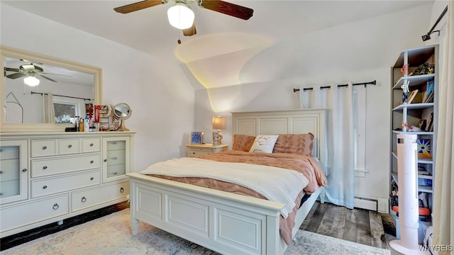 bedroom featuring lofted ceiling, a baseboard radiator, and ceiling fan