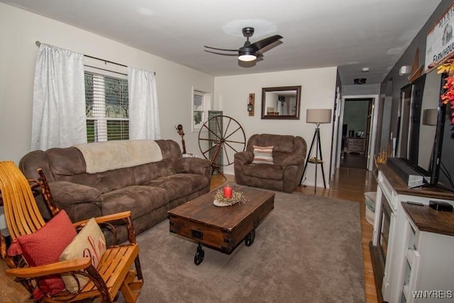living area featuring wood finished floors and ceiling fan