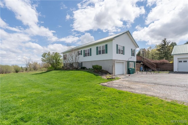 view of front of house with stairway, a garage, concrete driveway, and a front yard