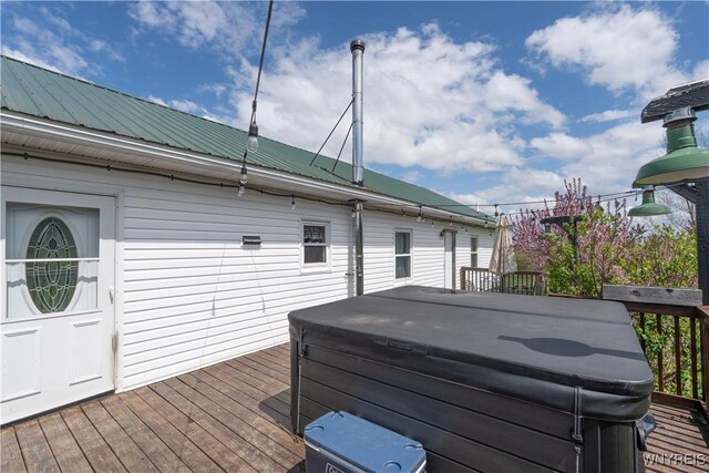 wooden deck featuring a hot tub
