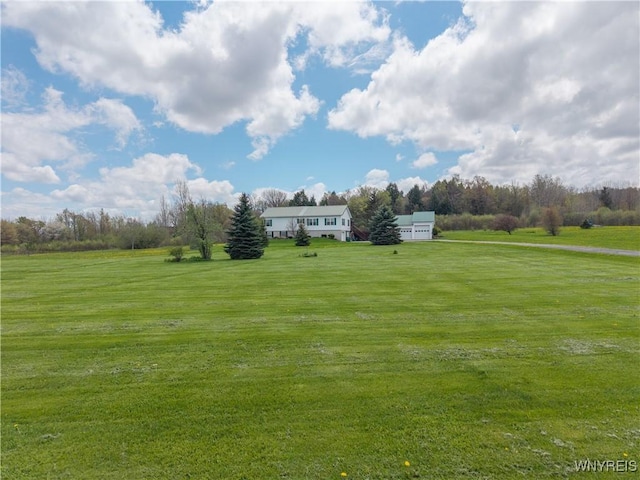view of green lawn with a view of countryside