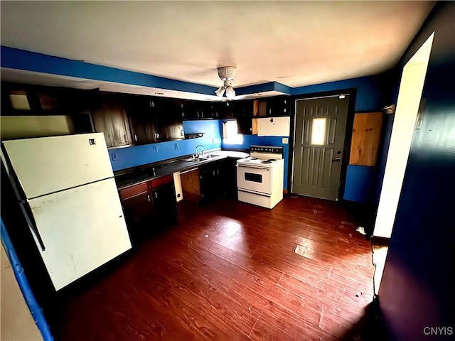 32 Spencer St, Gouverneur, NY 13642 - kitchen with white appliances, dark wood-style flooring, a sink, and dark countertops