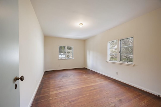unfurnished room featuring wood finished floors and baseboards