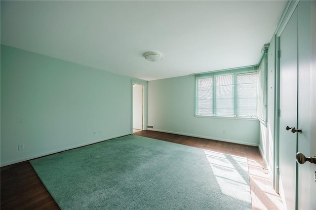 unfurnished bedroom with baseboards and carpet