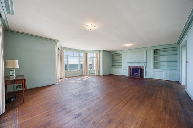 unfurnished living room with crown molding, dark wood-style flooring, built in features, baseboards, and a brick fireplace
