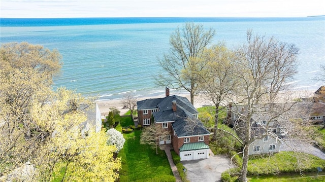 aerial view of property and surrounding area featuring a nearby body of water