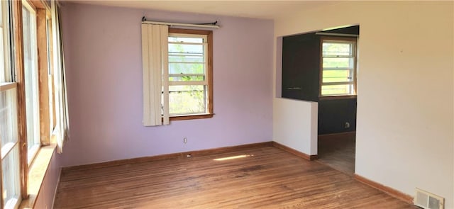 unfurnished room with wood finished floors and baseboards