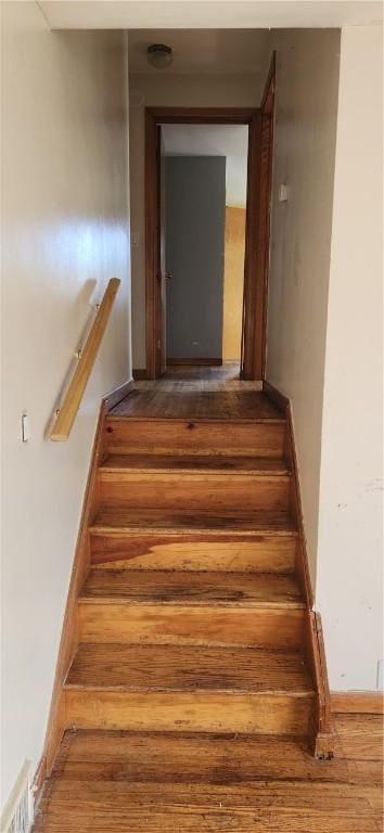 stairs featuring wood finished floors