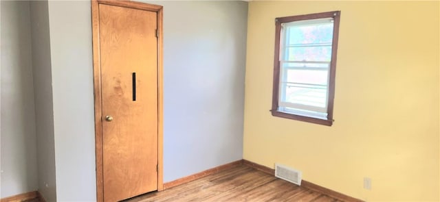 unfurnished bedroom featuring light wood finished floors and baseboards