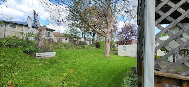 view of yard with an outdoor structure and a storage shed
