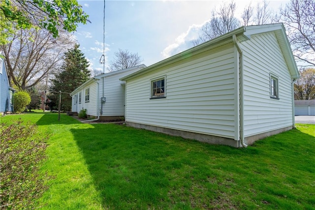 view of side of home featuring a yard
