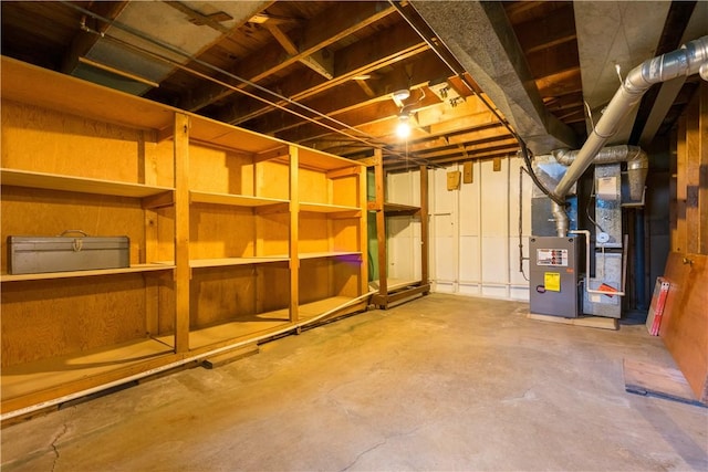 unfinished below grade area featuring heating unit