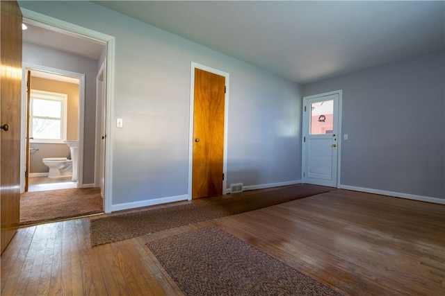 entryway featuring hardwood / wood-style flooring and baseboards