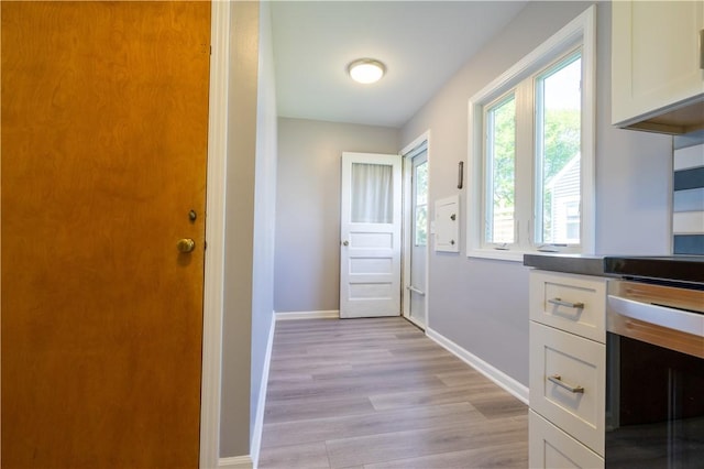 entryway with light wood-style floors and baseboards
