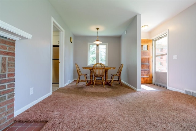 dining space with carpet and baseboards