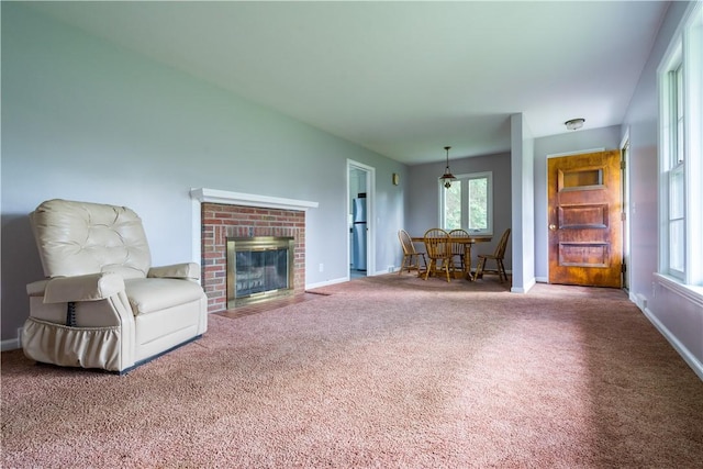 living area with carpet flooring, plenty of natural light, baseboards, and a fireplace