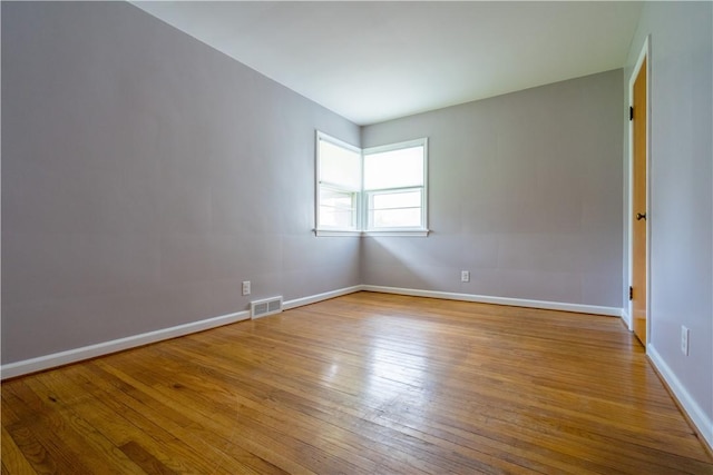 empty room with wood finished floors and baseboards