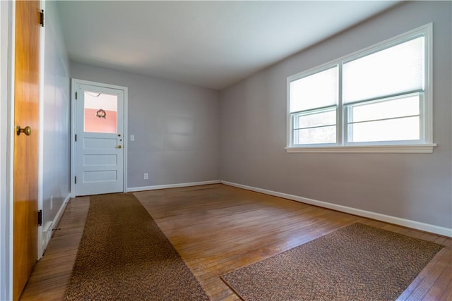 unfurnished room featuring wood finished floors and baseboards