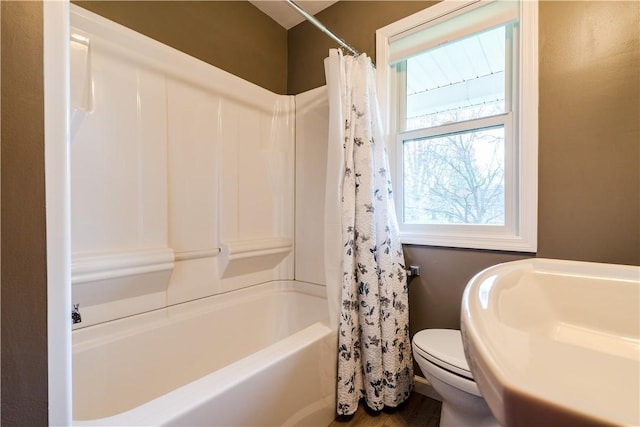 full bathroom featuring toilet, shower / bath combo, and wood finished floors