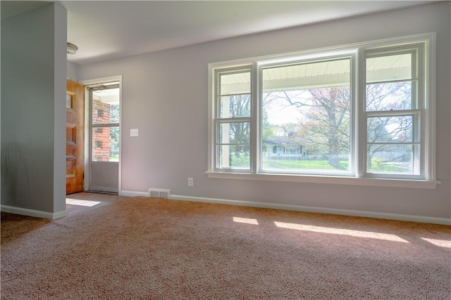 empty room with carpet and baseboards