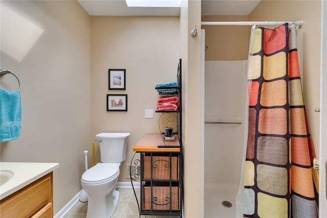 full bathroom with a stall shower, toilet, vanity, and baseboards