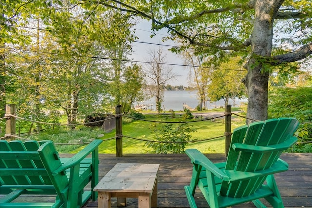 deck with a water view and a lawn