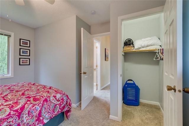 bedroom featuring carpet floors, a ceiling fan, and baseboards