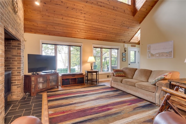 living room featuring healthy amount of natural light, a fireplace, wooden ceiling, and high vaulted ceiling