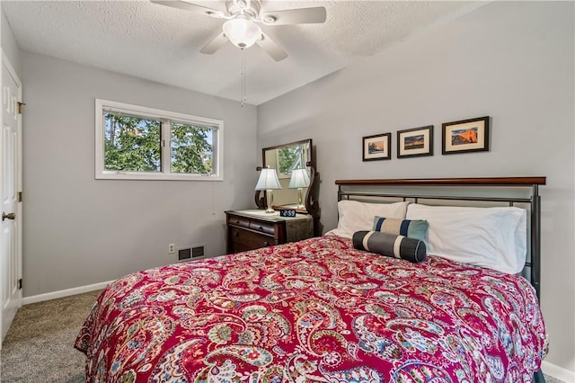 carpeted bedroom with baseboards, a textured ceiling, and ceiling fan