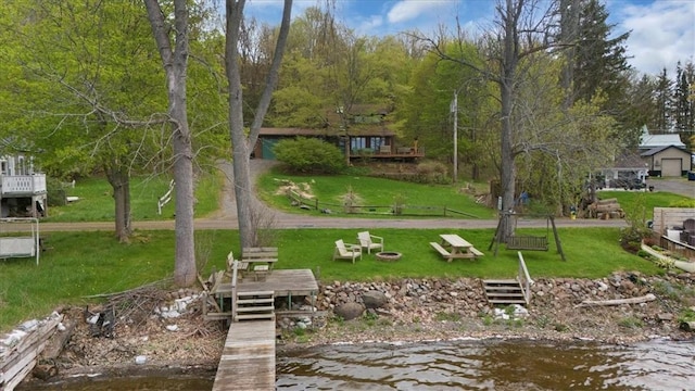view of home's community with a yard and a water view