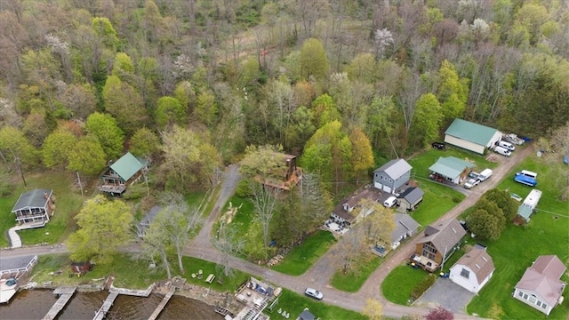 aerial view of property and surrounding area with a forest