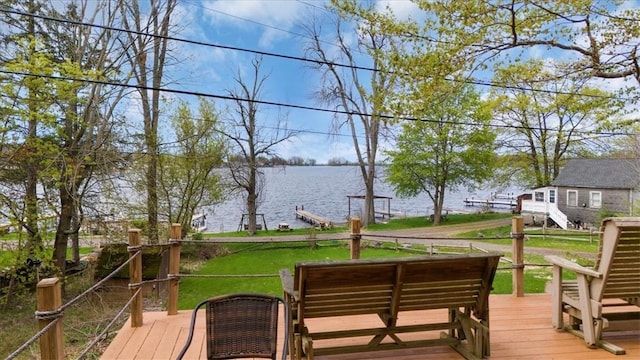 wooden deck with a water view, a lawn, and an outdoor hangout area