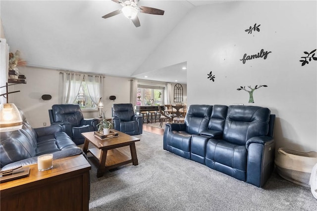 carpeted living room with a ceiling fan and high vaulted ceiling