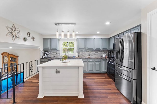 kitchen featuring stainless steel refrigerator with ice dispenser, gray cabinetry, black range with gas stovetop, dark wood-style flooring, and recessed lighting