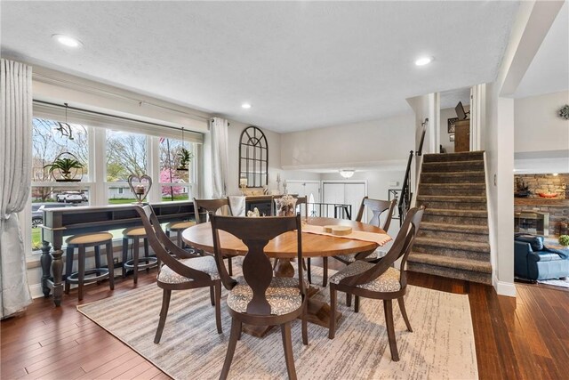 dining room with stairway, wood-type flooring, and recessed lighting