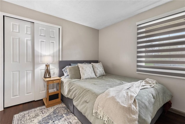 bedroom featuring multiple windows and wood finished floors