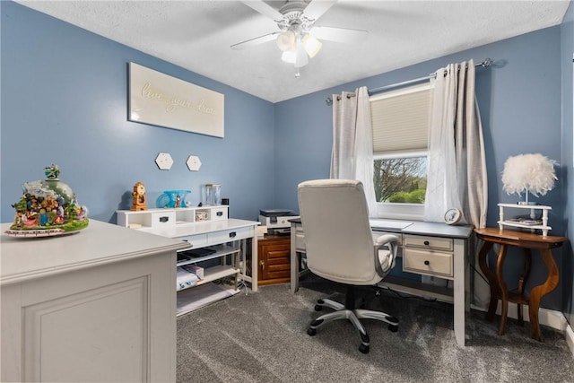 carpeted home office with a ceiling fan and a textured ceiling