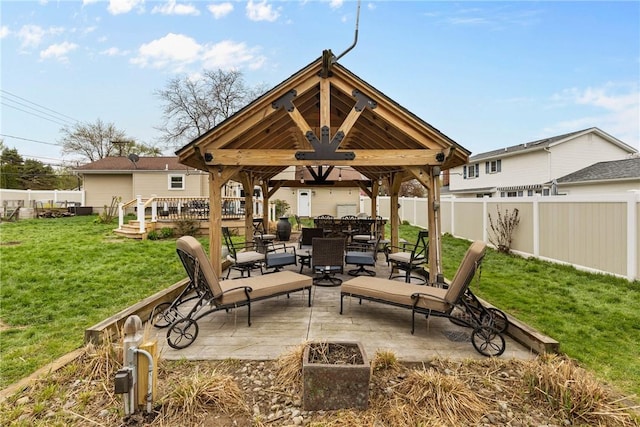 view of patio featuring a gazebo, a deck, and outdoor dining area