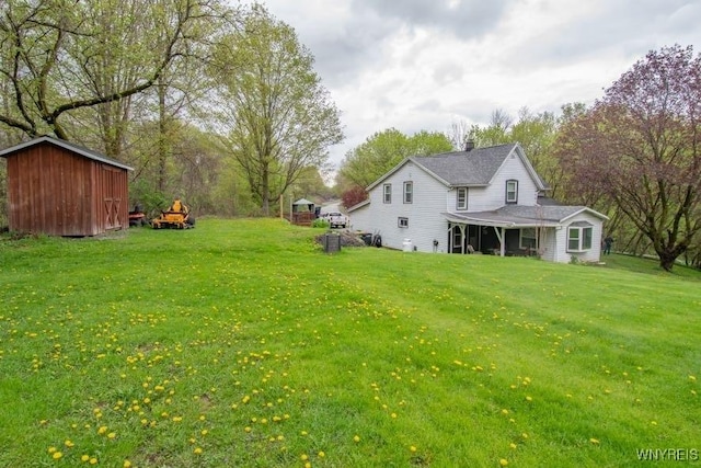 4182 Dutton Rd, Gainesville, NY 14550 - view of grassy yard with a storage unit and an outdoor structure