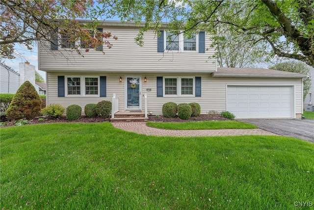 7745 Whiffletree Ln, Clay, NY 13090 - colonial-style house featuring asphalt driveway, an attached garage, and a front yard