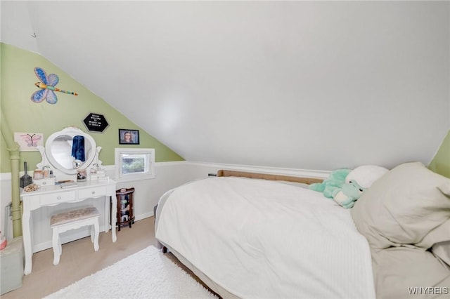 carpeted bedroom with lofted ceiling and baseboards