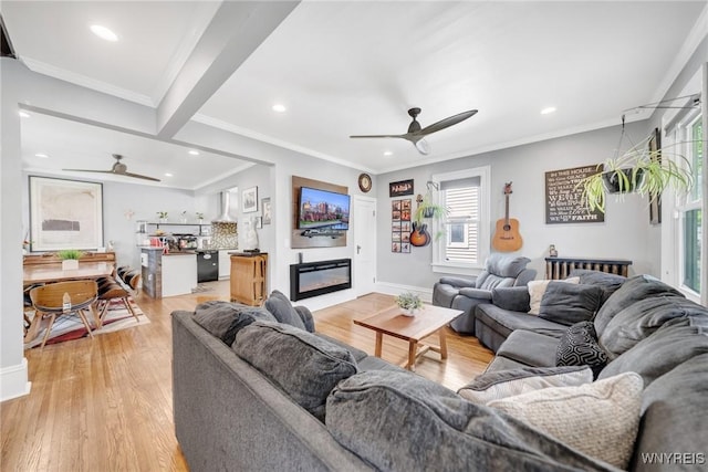 living area featuring a ceiling fan, recessed lighting, light wood-style flooring, baseboards, and ornamental molding